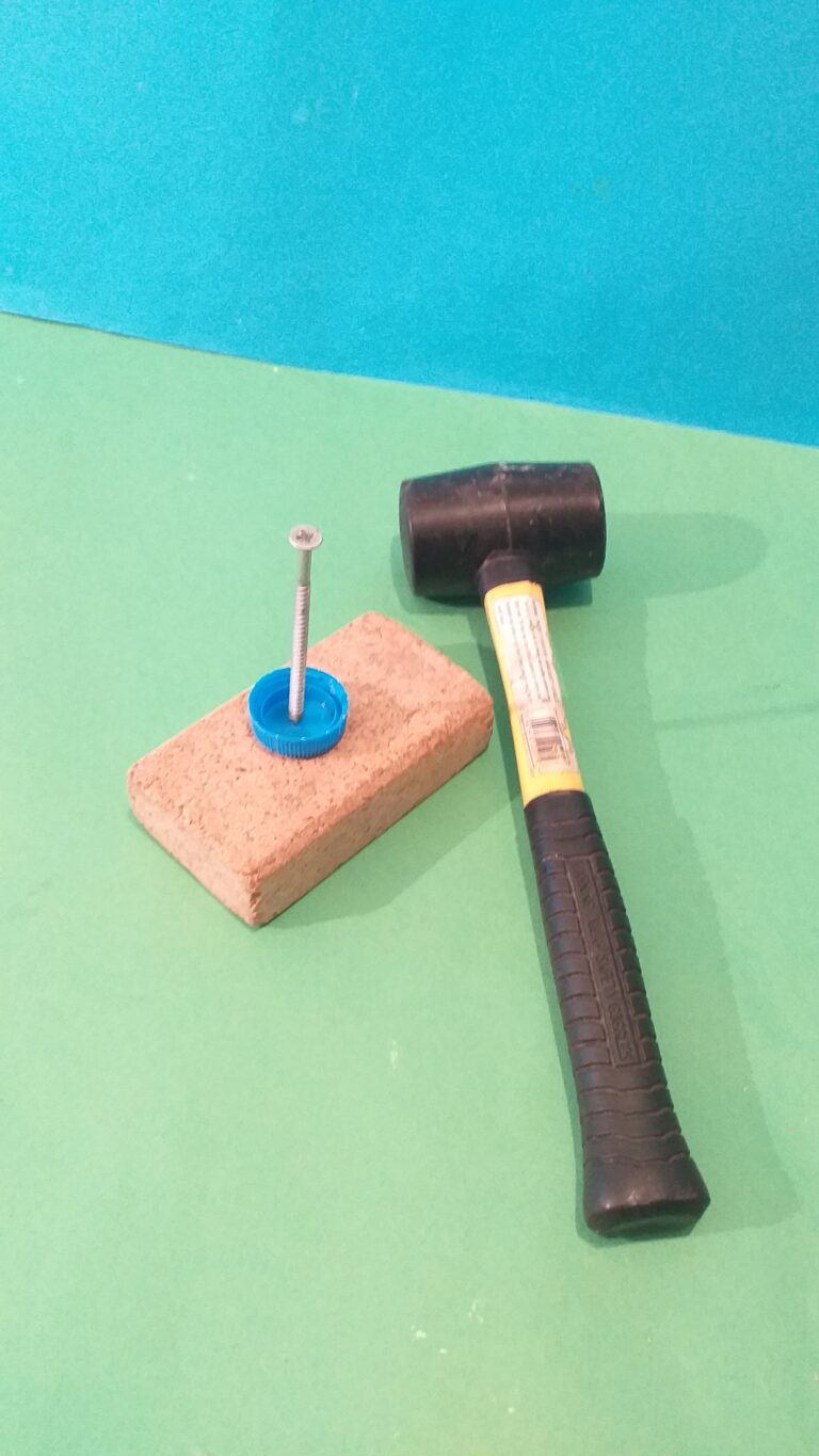 1) Hammer a screw nail into the plastic top.