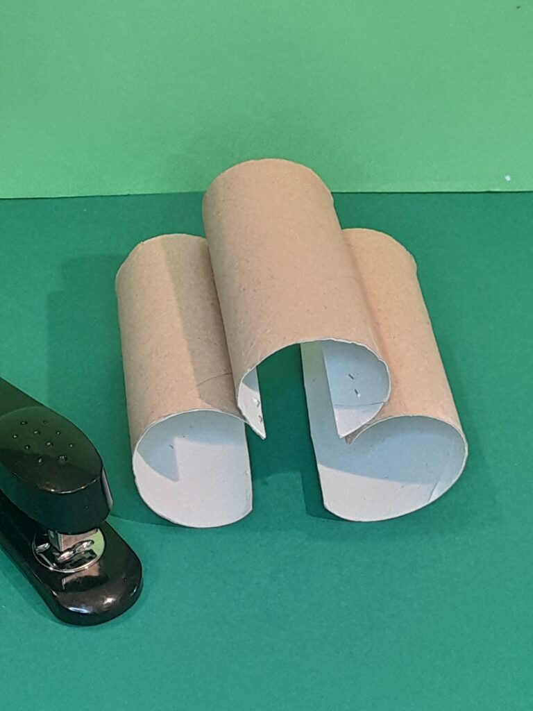 1) Cut long ways 3 tubes and staple together like so.