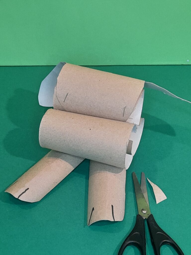 7) Staple feet to the base of the first tube.