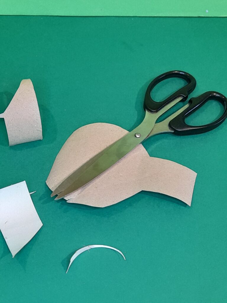15) Now flatten another tube and round off one part and make a neck like shape.