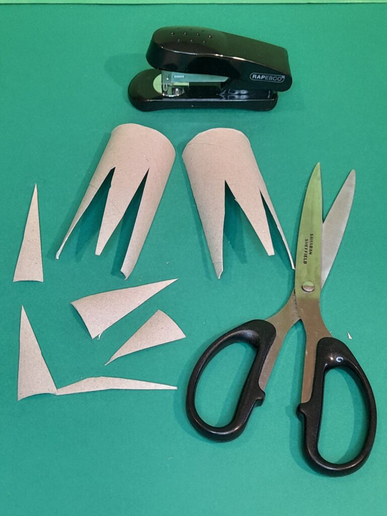 17) With another tube cut two feet with pointed toes.