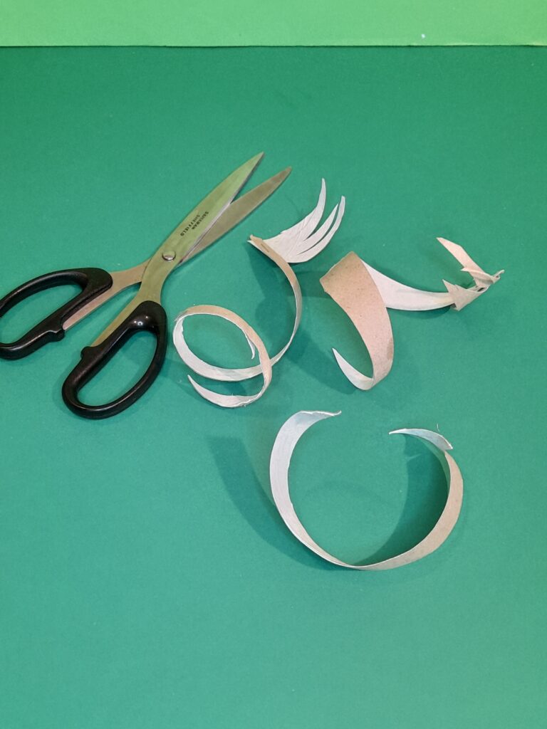 20) Now cut strips into finer strips and add pointed parts to the end for hands.
