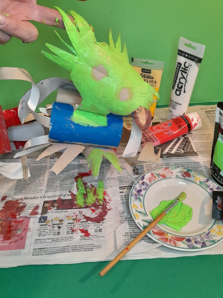 23) Bright green for the face leave out eyes to paint in yellow and paint blue the vest.