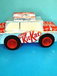 12) Stick logo on side of car and finish off by sticking more Kit Kats on the roof of car, with double sided tape.
