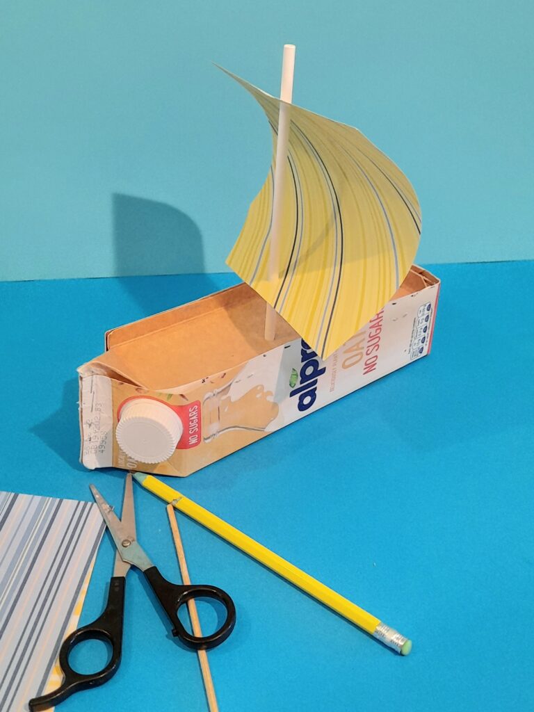 8) Run the straw through the holes.This is what a square sail would look like. For a triangle sail...