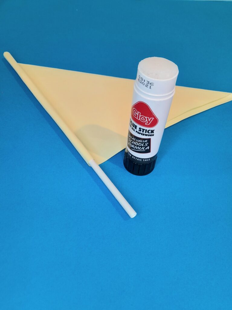11) Now press firmly and roll straw to adhere to paper, keep adding glue and roll. This is the triangle sail.