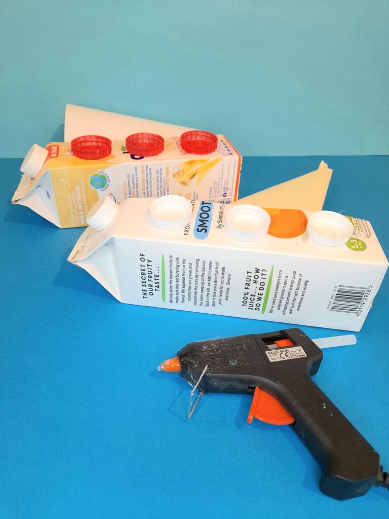 13) With glue gun add bottle tops, glue back of lids so inner parts show.