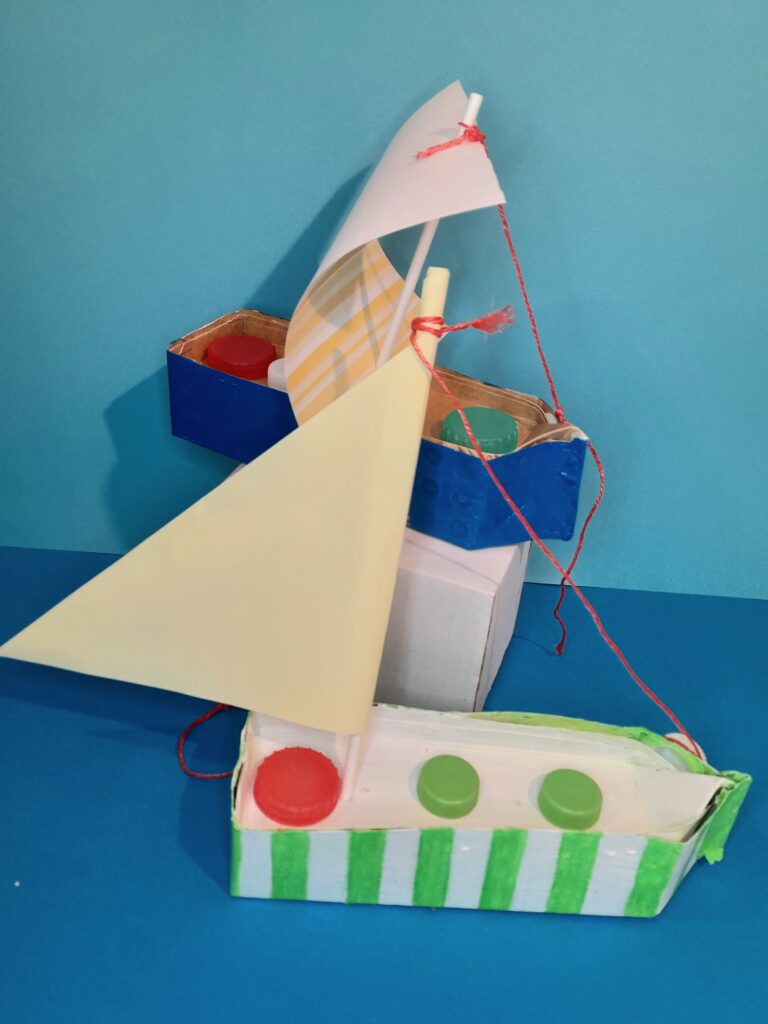 21) On the otherside of carton no lids to the side and sail is facing the other way.