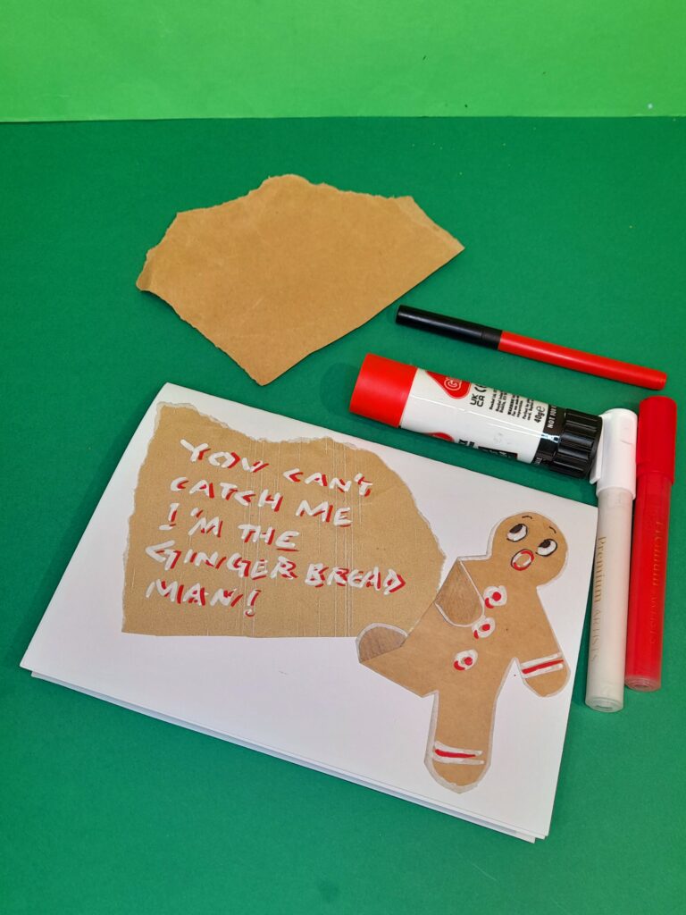 18) On the front glue on a torn piece of packaging paper and the gingerbread man, fold part of leg and arm to make him look like he is running.
