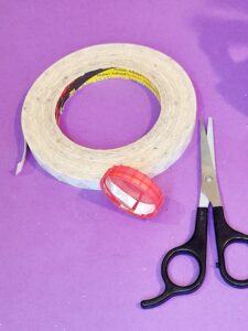 14) Cut thin strips of double-sided tape and stick inside lid to adhere it on end of pumpkin.