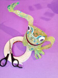 20) Grab the plastic bottle frog, the legs are extended stick them down onto its body.