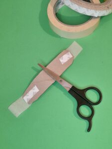13) Stick a piece of double sided tape to either end, plus some masking tape.