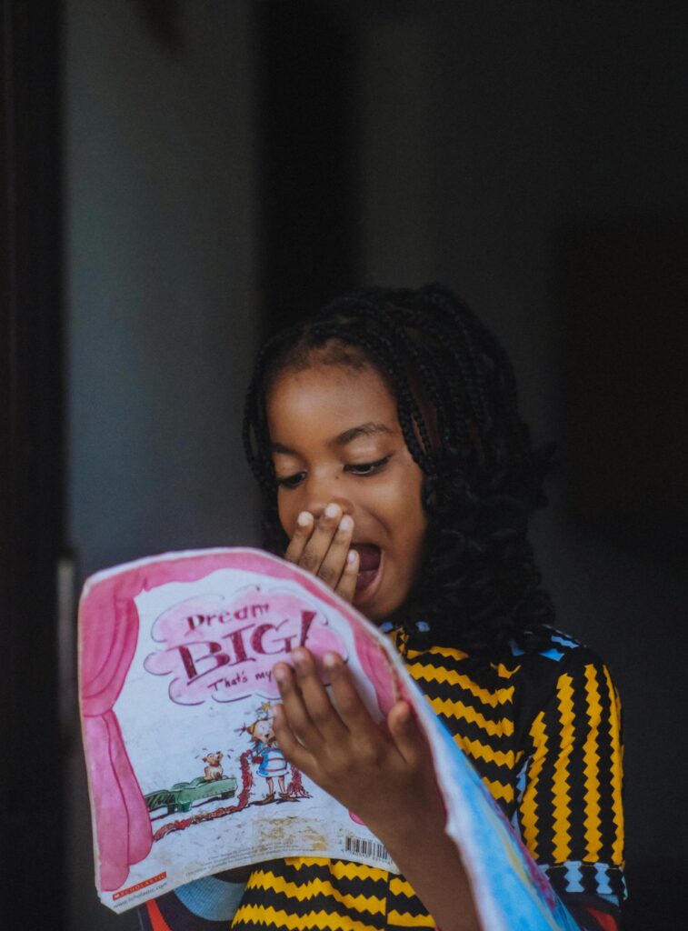 Girl surprised reading book A pexels picture by wavy revolution.