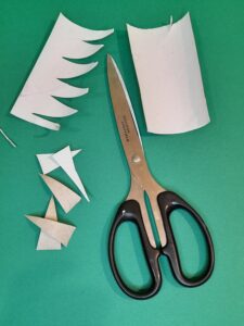 2) Take another tube and cut vertically and cut in half. Snip out points like teeth along each piece.