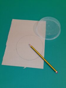 14) Draw around the 12cm wide plastic tub making a circle on the brown card.