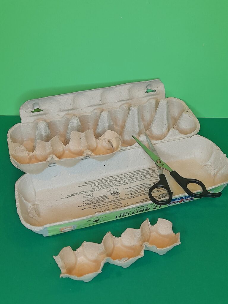 1) Grab a long twelve egg cup box, cut one long section out, or two three egg cup pieces.