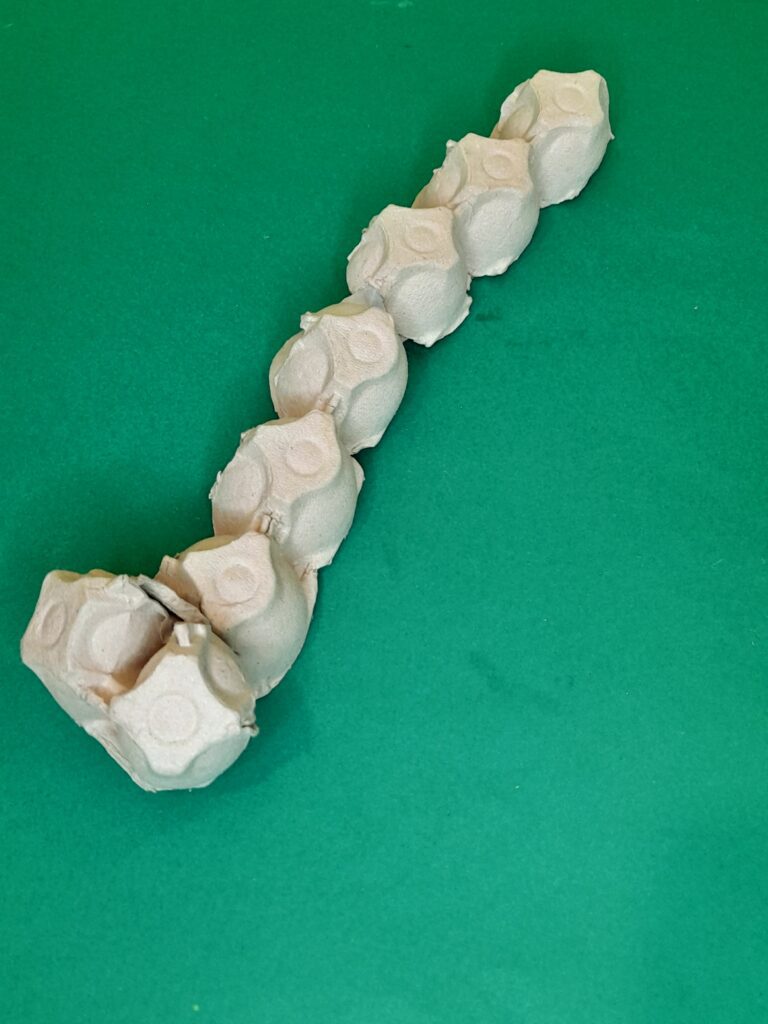 7) Cut a slit in the body of the egg cup and you can push in the pointed bit and then glue into place.