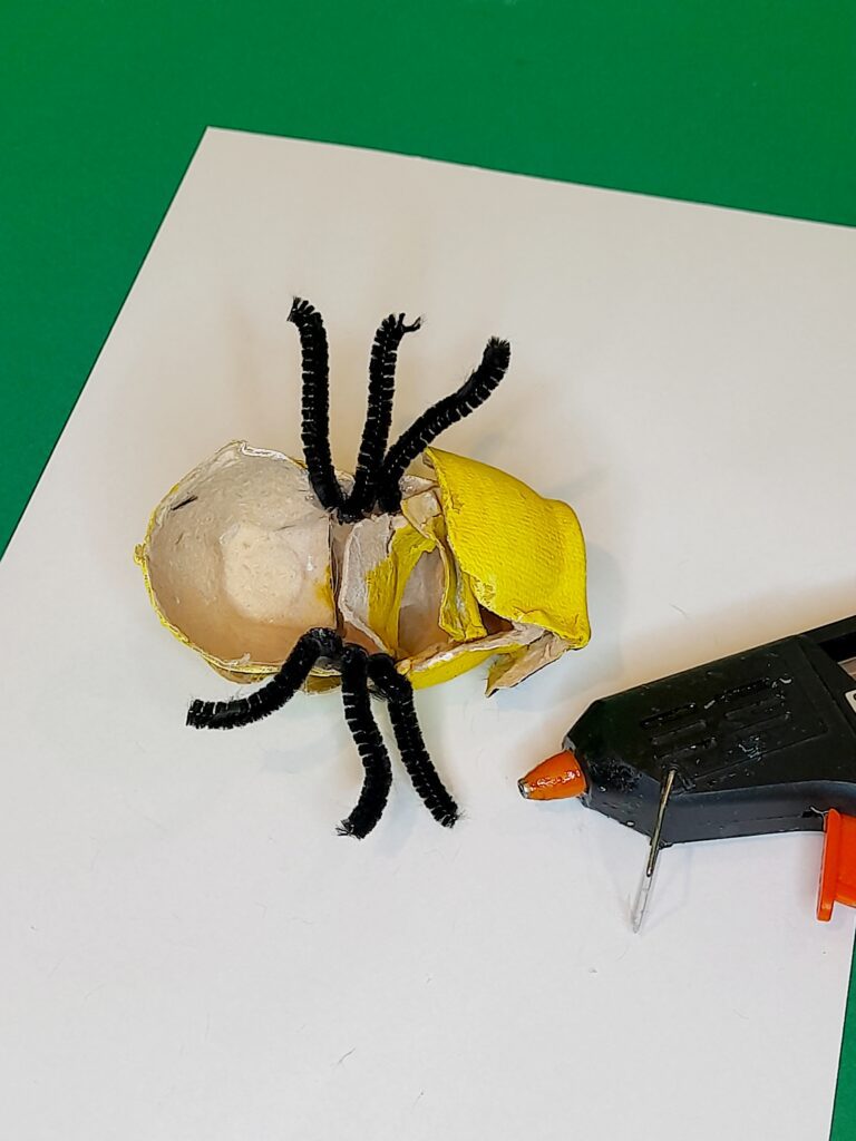 7) Turn over and cut 6 legs from black pipe cleaners, hot glue on the underside.