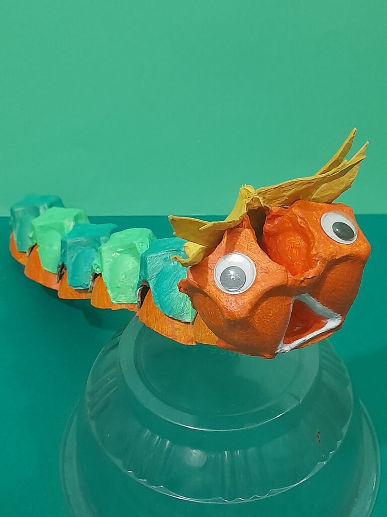 15) Finally paint the triangular mouth in white. This gives the caterpillar a surprised look!