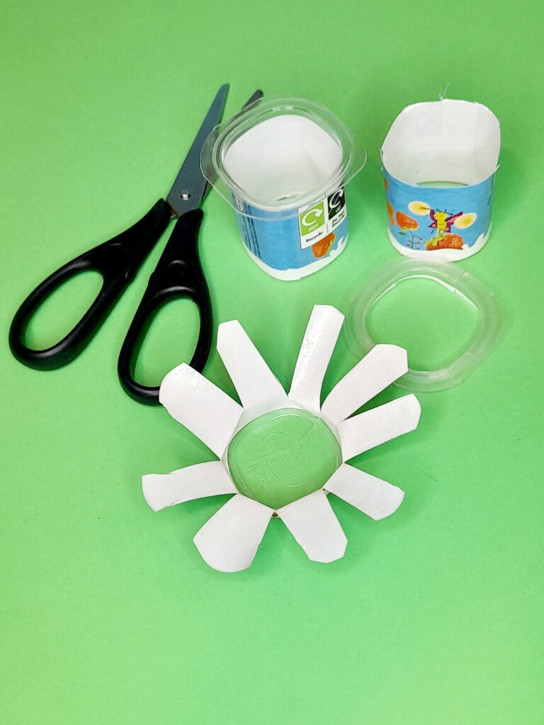 10) Take small yogurt pots cut off the hard bit and them snip all the way around.