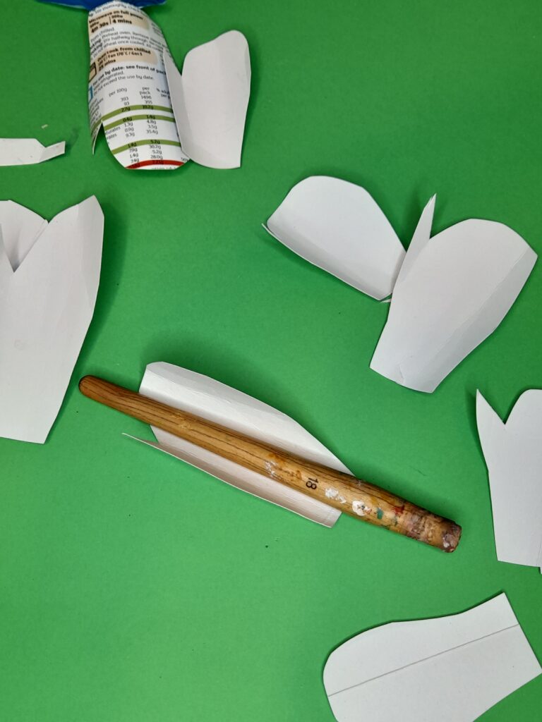 21) Cut a few of these leaf shapes and slightly curl each one to bow it.