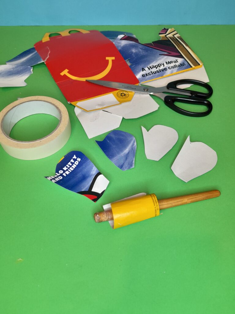 20) Take Mcdonalds packaging, or soft recycled packaging. Cut petals as shown with a slight point to one side. Curl a long piece to make the inside of a flower.