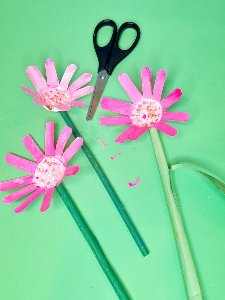 12) When painted glue with hot glue on a green painted stem, now trim all the way around each petal.