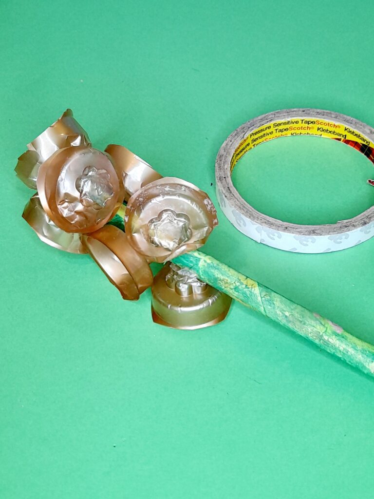15) Neaten off, now stick using double sided tape onto a long stem, bunch them up as shown.