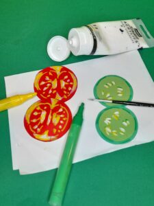 8) Now use acrylic pens or paints to colour the insides of a tomatoes and cucumbers.