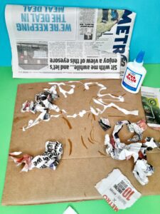 Scrunch up newspaper ready to glue onto tree.