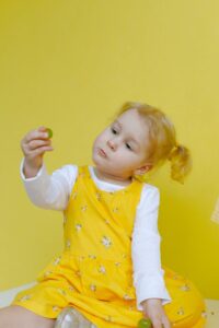 Girl thinking about her egg box dinosaur for kids!