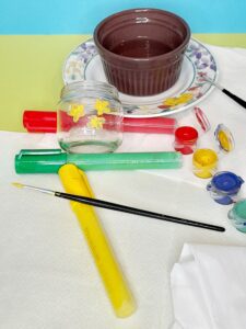 Paint the glass jar with small yellow flowers.