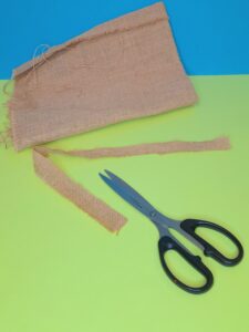 Cut hessian strip to tie around the jar.