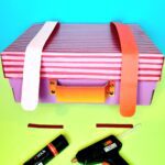 Position and glue on to box add handle, and 2 buckles.