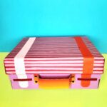 Glue on the straps, attach handle with split pins and glue on buckles.