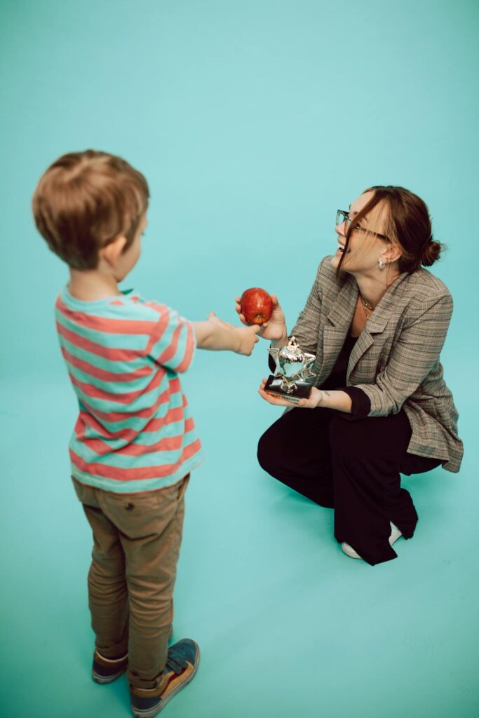 School boy gifting his teacher.