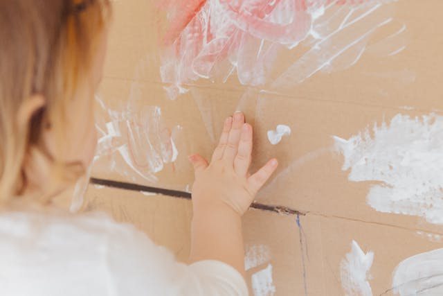Child painting using her hands.