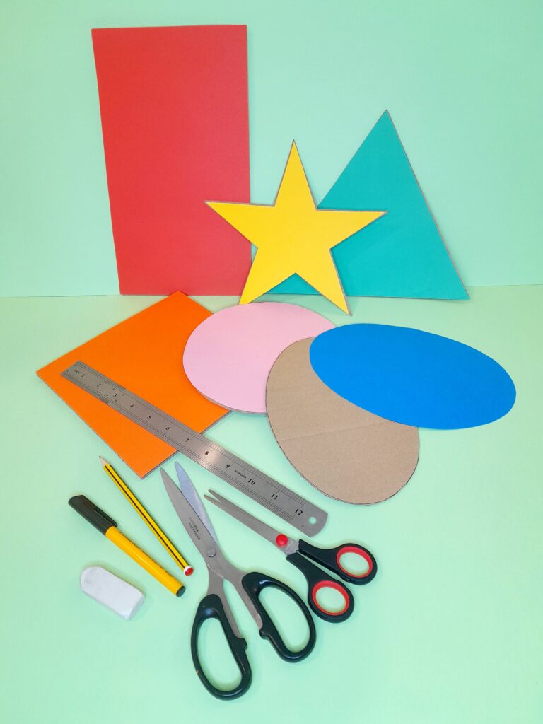 6 2d shapes are cut out of coloured card and same shapes out of packaging card.