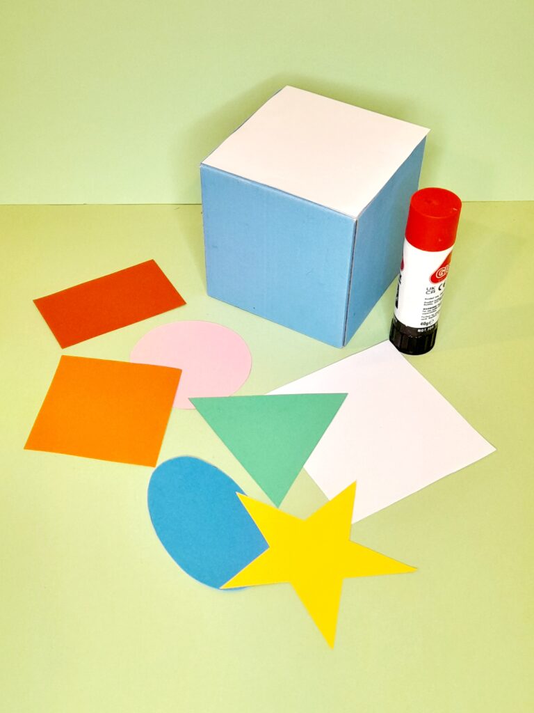 Stick on the shape on the cube.