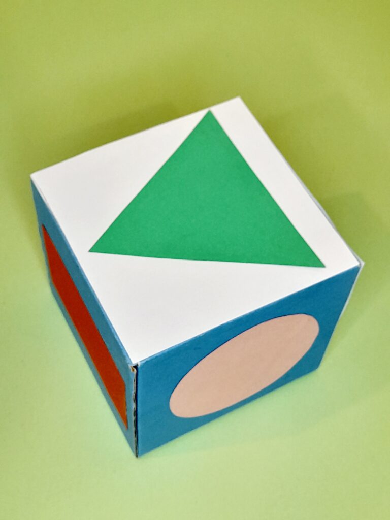 Cube showing triangle, circle and rectangle.