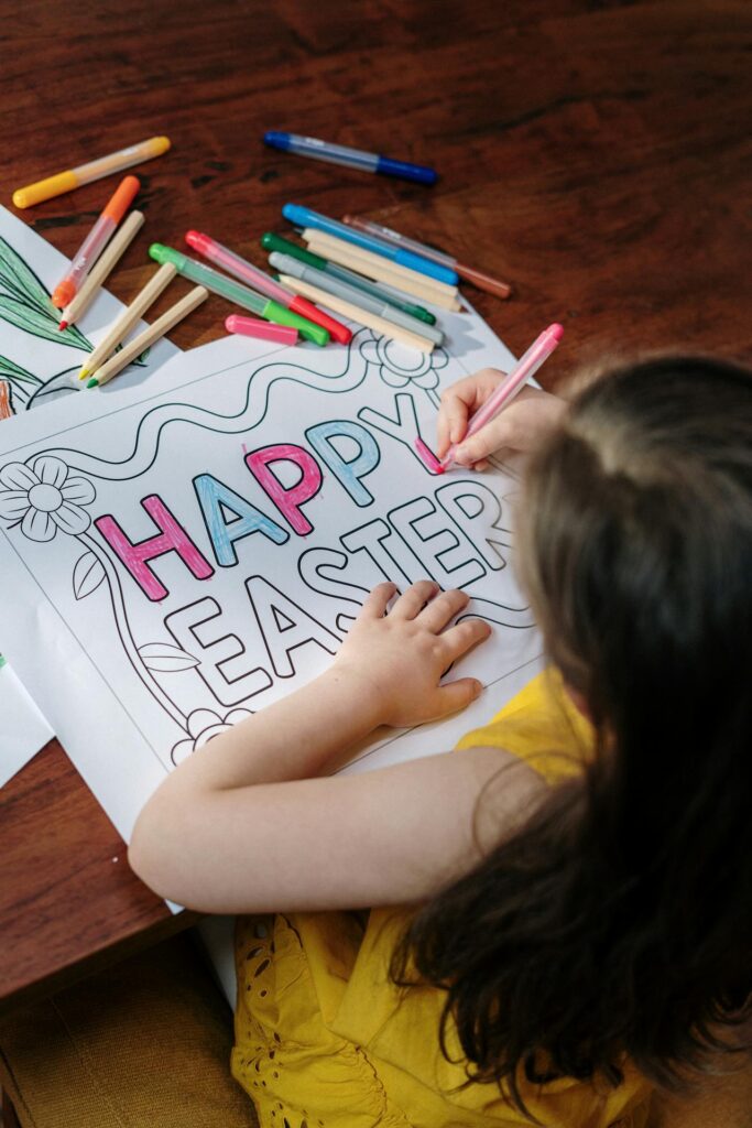 Girl colouring in Happy Easter.