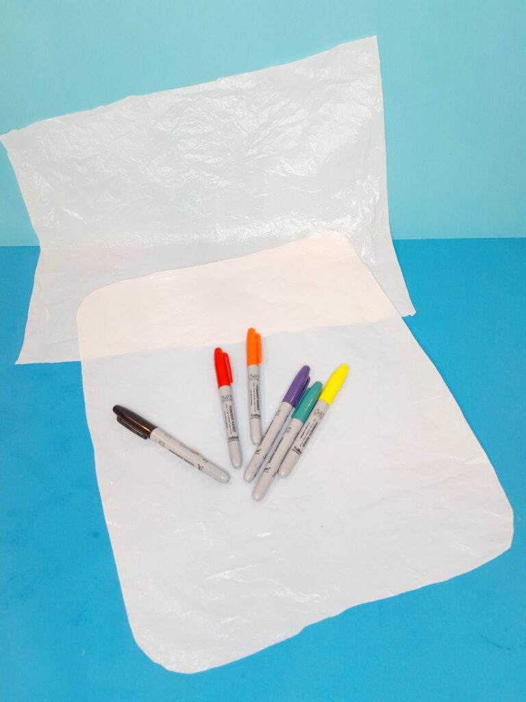 Use colour permanent pens to colour the plastic sheets.