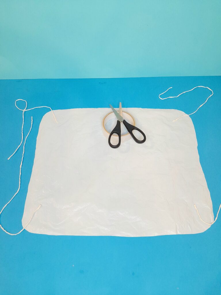 Tape each woollen strand to each corner of the plastic sheet.