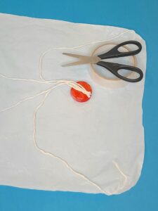 Tape the strands to the bottle cap.