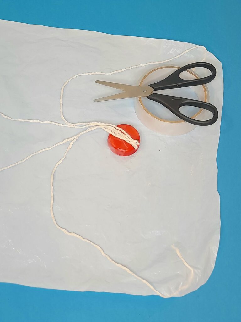 Tape the strands to the bottle cap.