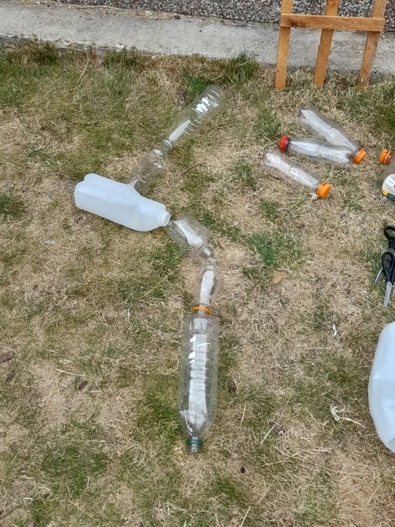 Lay plastic bottles how they will be on the trellis.